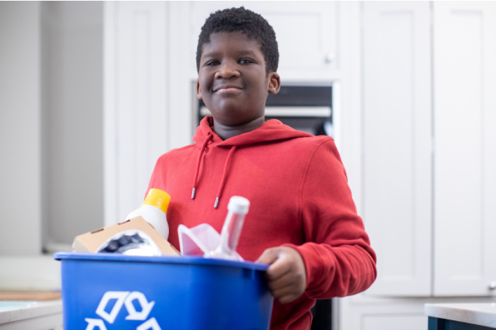 Age appropriate family chore chart - Kids Activities Blog - older boy carrying out the recycling bin