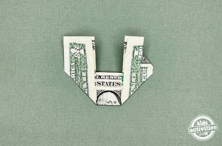 Dollar bill Christmas wreath tutorial - step 3 - tuck the top corners to form small triangles on each side