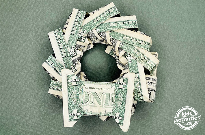 Finished result - dollar bill origami Christmas wreath tutorial from Kids Activities Blog