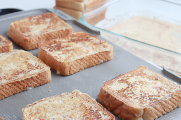 Easy Eggnog French Toast - Eggnogg French Toast cooking on a black electric griddle - Kids Activities Blog 