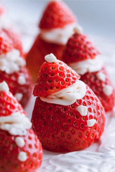 Easy Strawberry Santas are a Healthy Christmas Strawberries Treat - Santa hat snack made with strawberries and whipped cream - Kids Activities Blog