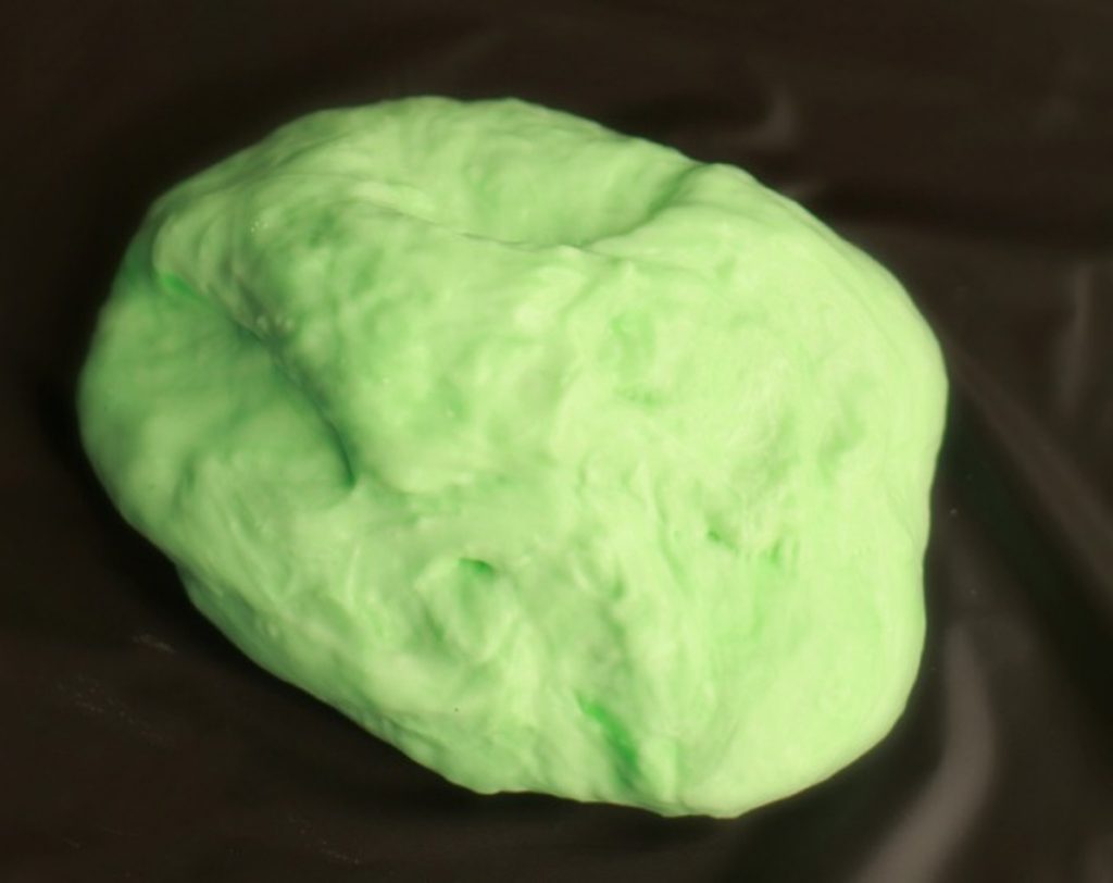 ideas for christmas homemade gifts- Image shows a green silly putty on a table.