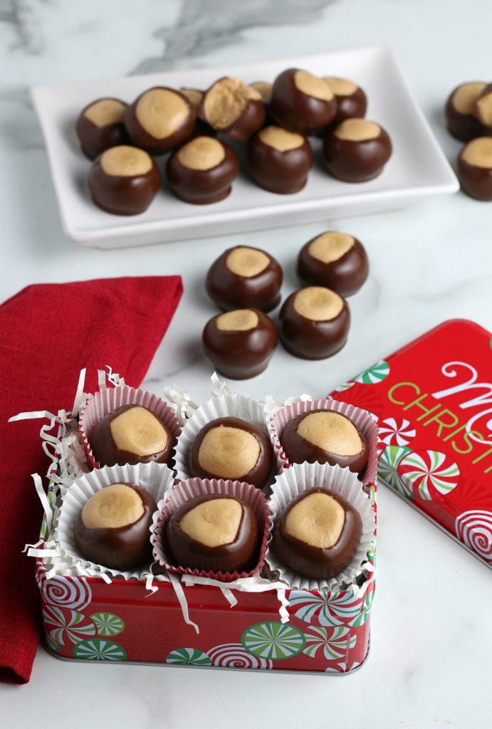 ideas for christmas homemade gifts- Image shows buckeye balls on a table with Christmas decorations.