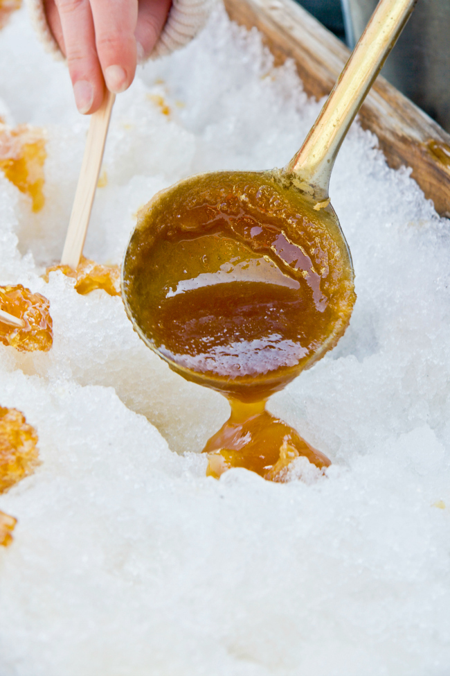 homemade snow candy shot from the video - ladel over snow filled with hot candy