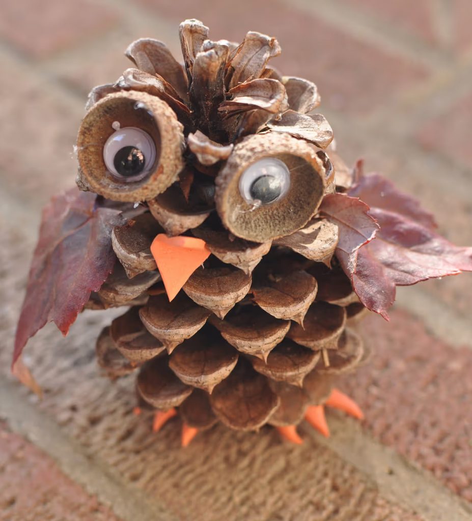 natural Christmas ornaments- Image shows a pine cone owl craft.