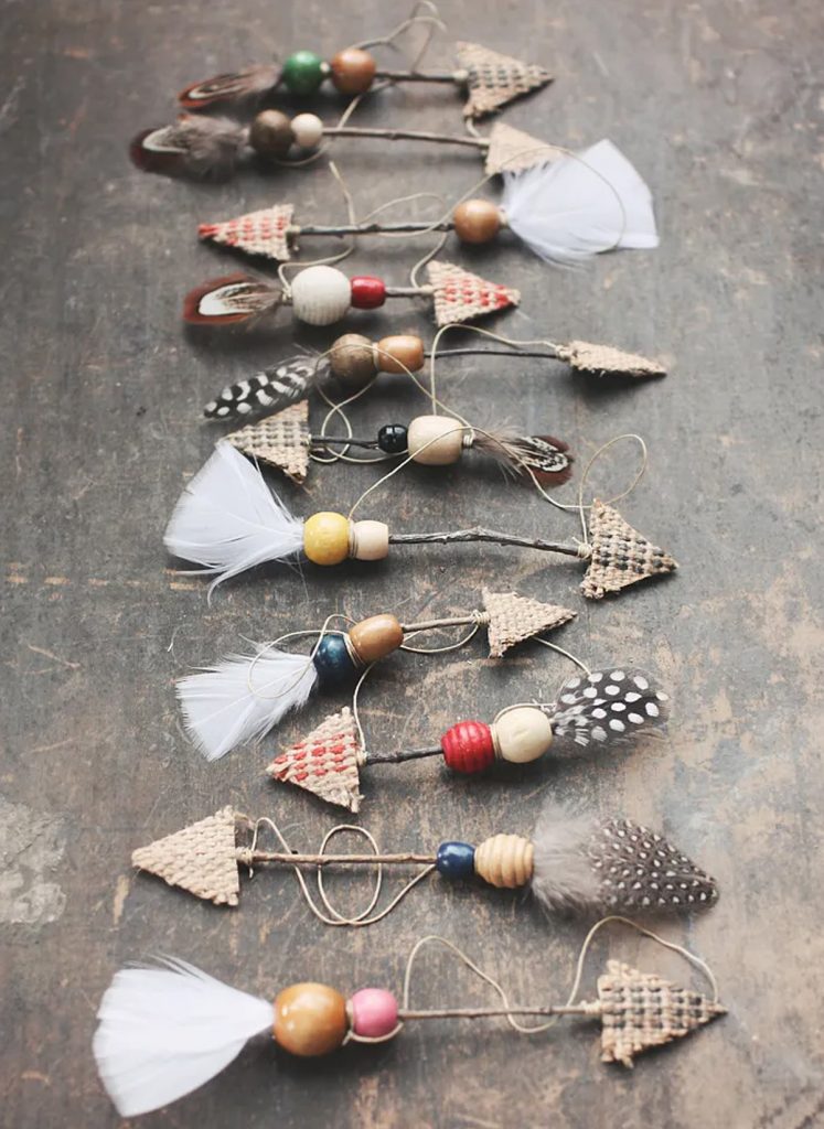 natural Christmas ornaments- Image shows rustic twig arrow ornaments on a table.