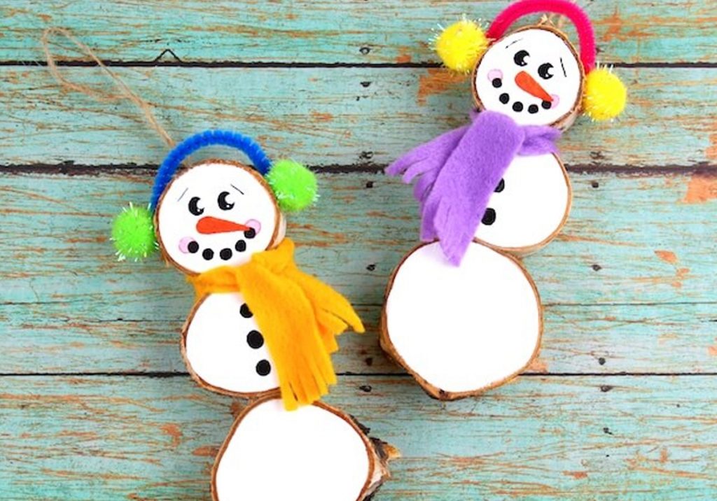 natural Christmas ornaments- Image shows two wood slice snowman ornaments.