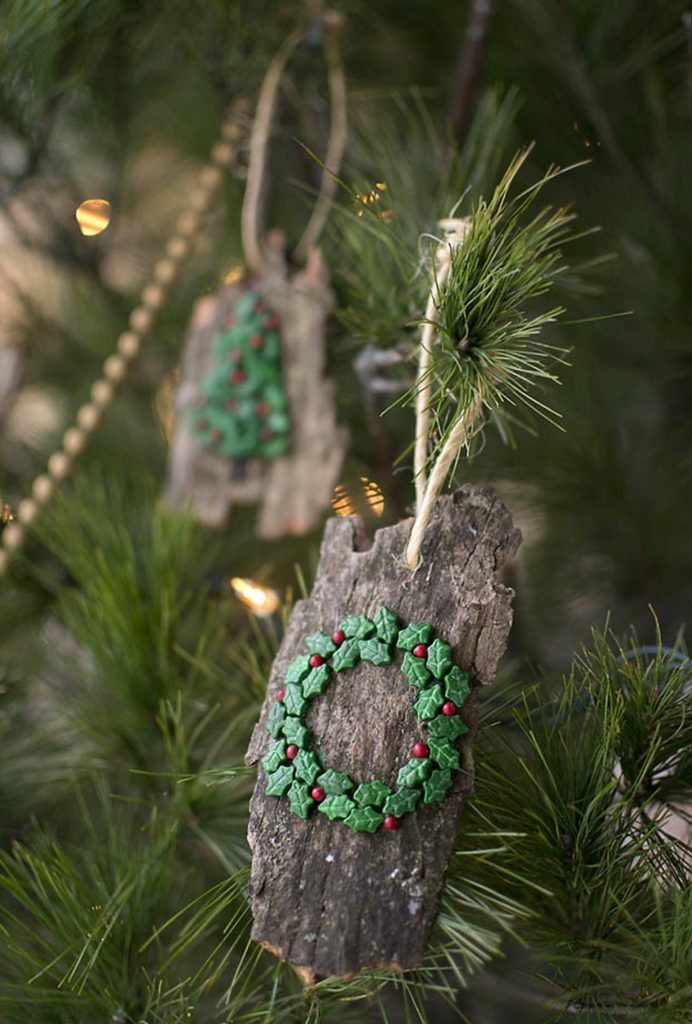 natural Christmas ornaments- Image shows at tree bark ornament hanging from a tree.