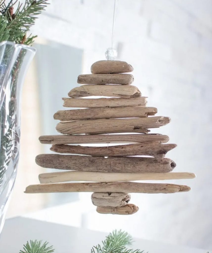 natural Christmas ornaments- Image shows a miniature DIY driftwood tree ornament hanging from a tree.