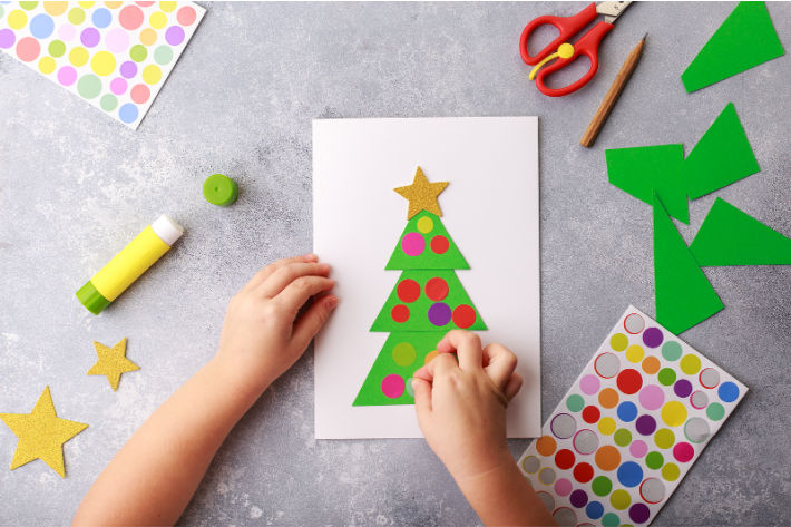 Preschool Christmas craft - paper Christmas tree made out of triangles and stickers