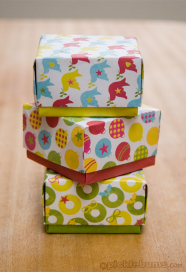 Christmas crafts like these free printable gift boxes with birds and starts, colorful ornaments, and yellow and green wreaths.