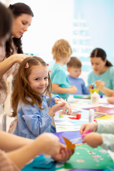 Little girl crafting coloring sheets with her mother