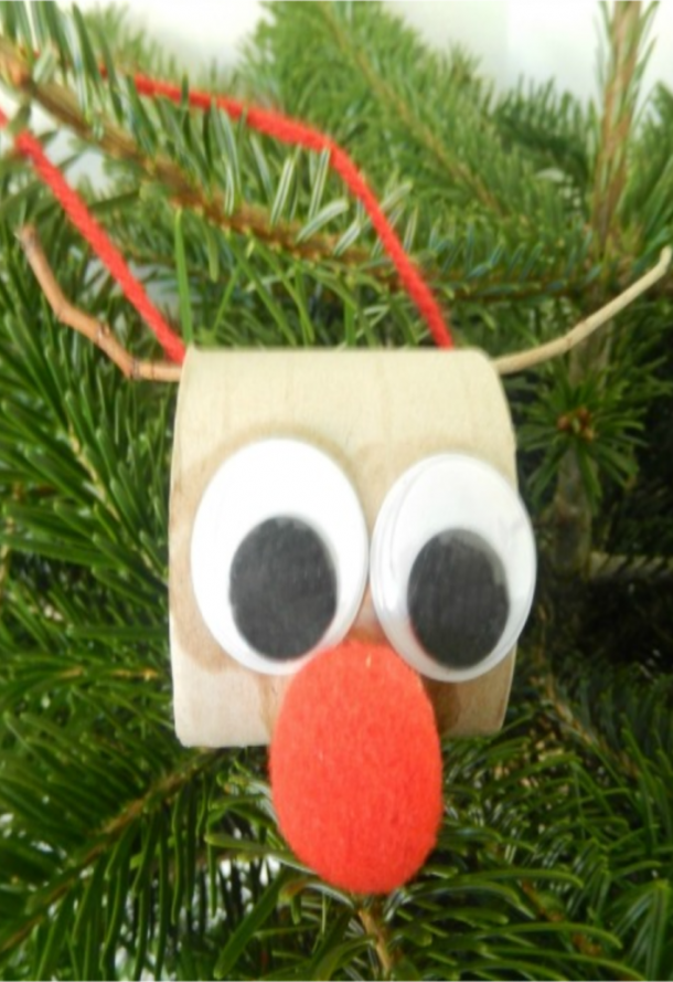 toilet roll Christmas reindeer with googly eyes, big pom pom nose, and stick antlers.